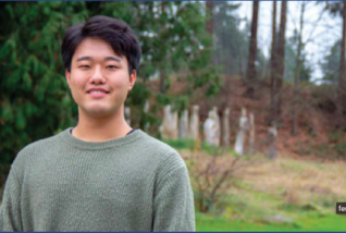 Smiling young man wearing a green sweatshirt